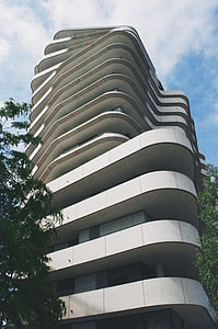white concrete tall building near tall tree thumbnail