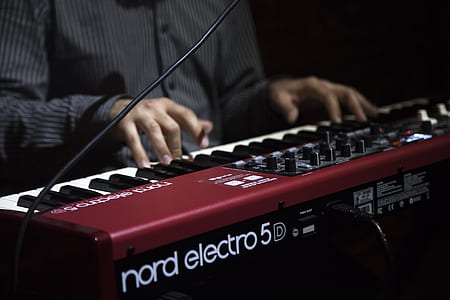 person playing maroon Nord Electro 5 electronic keyboard thumbnail