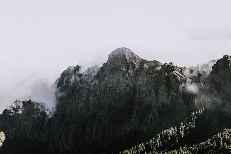 gray mountain covered with white fog during day time thumbnail