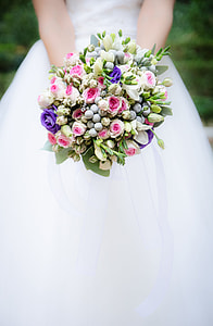 woman wearing white wedding dress holding flower bouquet thumbnail