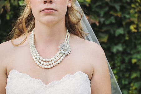 Woman in White Lace Strapless Sweetheart Bridal Gown White Bridal Veil and Pearl Beaded Necklace thumbnail