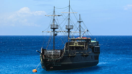 gray and black sailing boat on body of water thumbnail