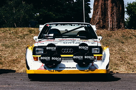 white Audi stock car on road near brown tree thumbnail
