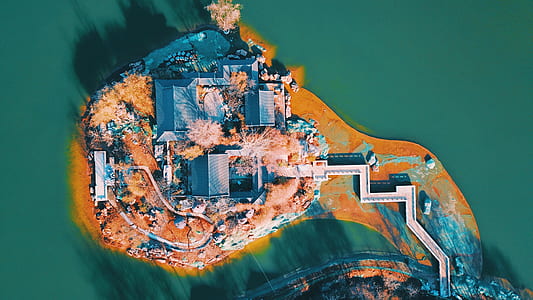 aerial view of gray houses near body of water thumbnail