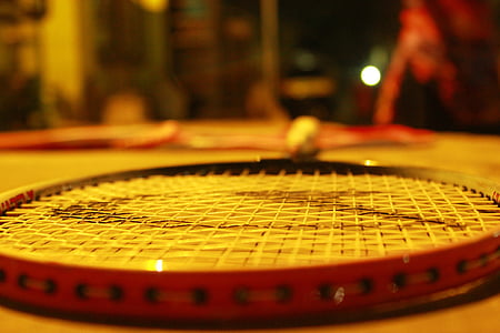 selective focus photo of black and red badminton racket thumbnail