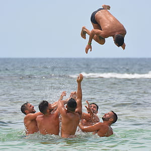 Group of Men in Body of Water thumbnail