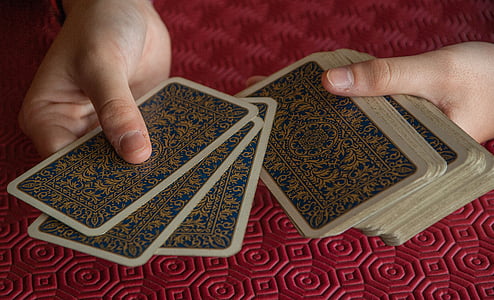 person holding playing cards thumbnail