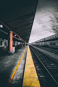 macro photography of train station under the cloudy sky thumbnail