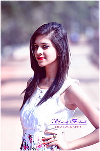 smiling woman wearing white sleeveless dress thumbnail