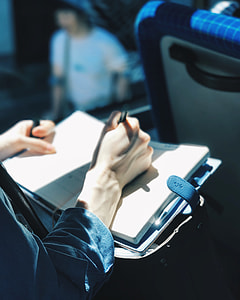 focus photography of person writing on notebook thumbnail