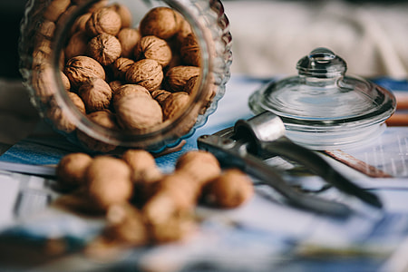 Jar full of walnuts with a fresh healthy shake and musli in a bowl thumbnail