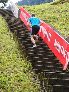 man climbing on stair during day time thumbnail