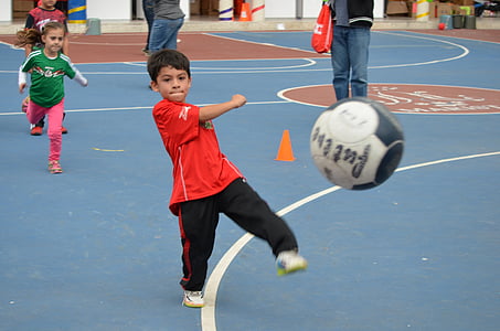 boy kicking white and black ball thumbnail