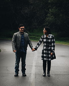 man and woman standing on road while holding hands thumbnail