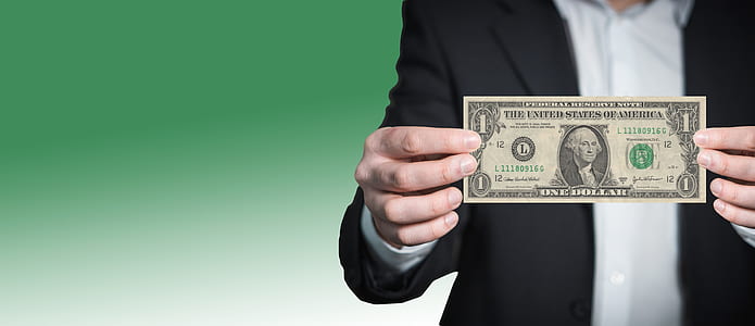 person holding 1 U.S. dollar baknote thumbnail
