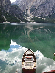 boat on body of water in front of alp thumbnail