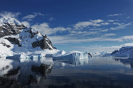 mountain covered by snow under white cloudy sky at daytime thumbnail