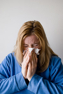 woman holding tissue paper standing near wall thumbnail