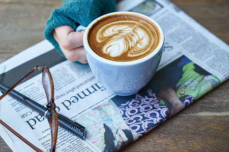 person holding white ceramic mug with cappuccino thumbnail