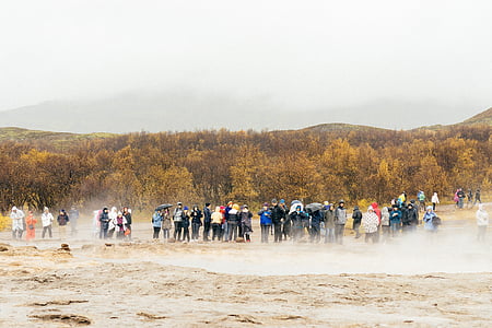 people standing on brown field thumbnail