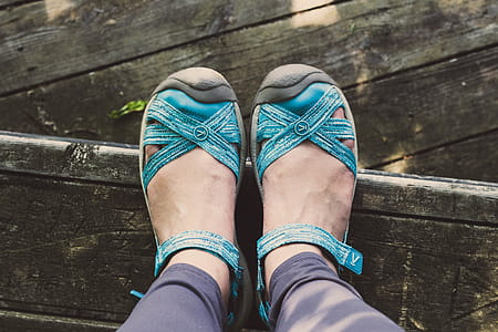 Person Wearing Pair of Blue Leather Sandals thumbnail