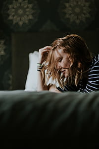 on bed, woman, touching hair, portrait thumbnail