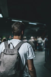 man carrying gray backpack thumbnail