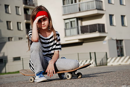 girl sitting on skateboard thumbnail