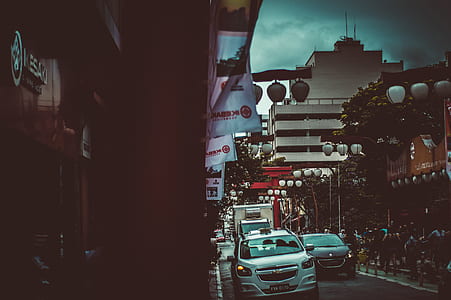 vehicles in street between buildings thumbnail