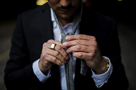 man holding his neck tie thumbnail