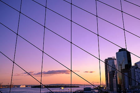 gray high rise building near body of water during sunset thumbnail