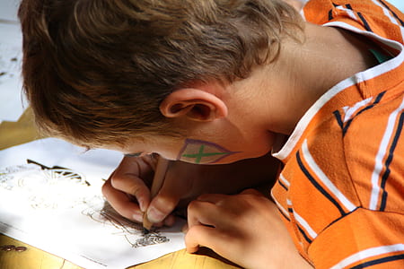 boy sketching on white printer paper thumbnail