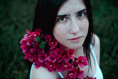 woman wearing white tank top with pink flowers on neck thumbnail