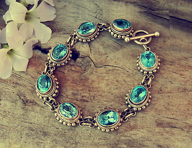 gold-colored blue gemstone encrusted bracelet thumbnail