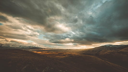 silhouette of hills during night time thumbnail