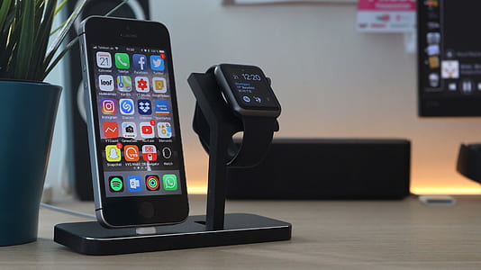 space gray iPhone 5s beside black aluminum case Apple Watch with black Sport Band thumbnail