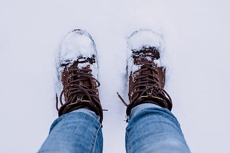 person standing on white snow wearing brown boots thumbnail