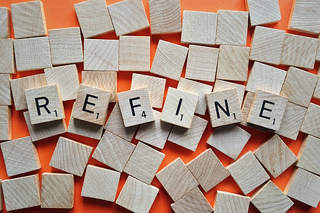 scrabble tiles forming the word refine on orange surface thumbnail