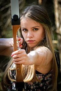 woman holding brown and black bow and arrow thumbnail