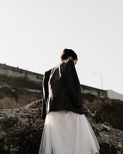woman standing beside rock thumbnail