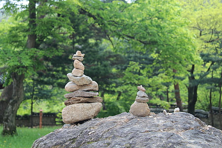 cairn stones on boulder at daytime thumbnail