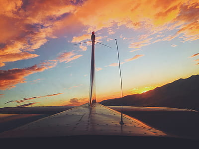 white windmill under orange and blue sky during sunset thumbnail