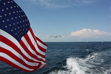 U.S.A flag beside body of water thumbnail