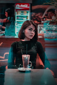selective focus photography of woman sitting on chair thumbnail