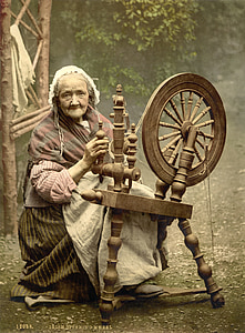 woman sitting holding holding spinning wheel photo thumbnail