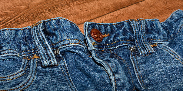 close-up photo of blue denim bottoms on brown wooden surface thumbnail