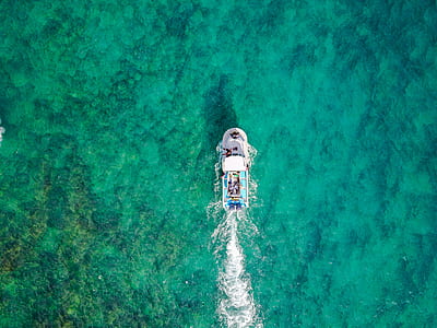 bird's eye view of yacht on body of water thumbnail