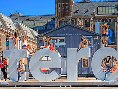 women standing near standee thumbnail
