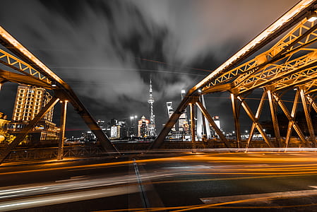 time lapse photography of bridge during night time thumbnail