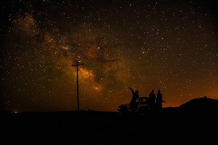 silhouette photography of people under the stars sky thumbnail